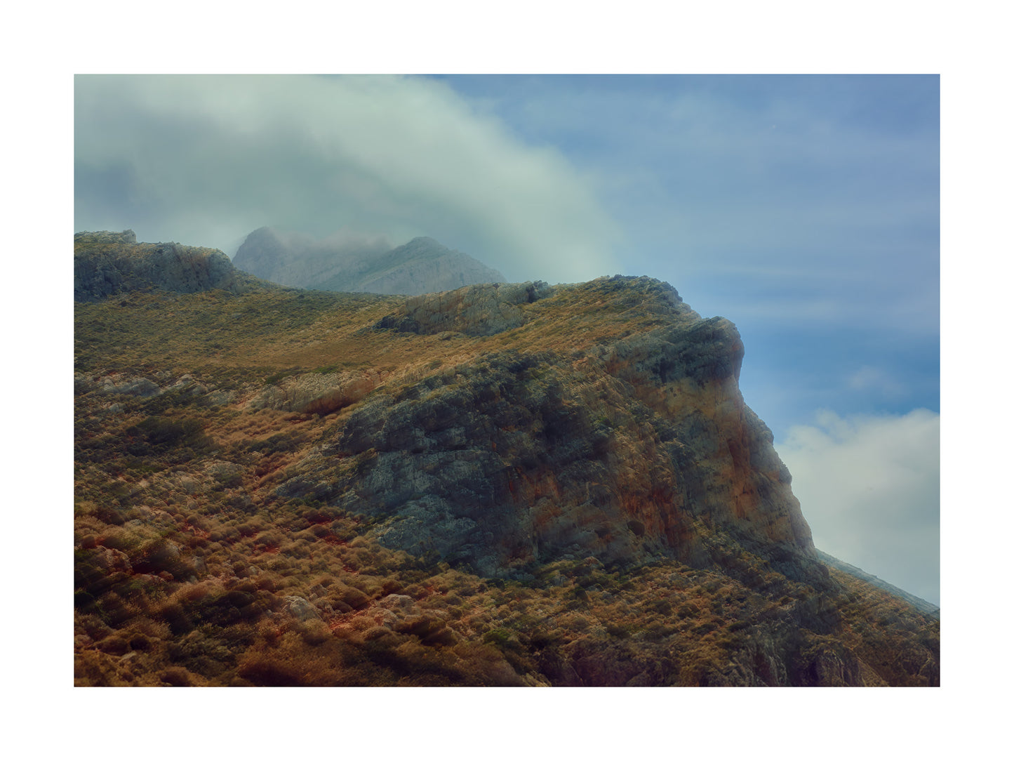 Fine Art Print by Lucas Castro Pardo of a Mountain landscape with rocky terrain and clouds in the sky