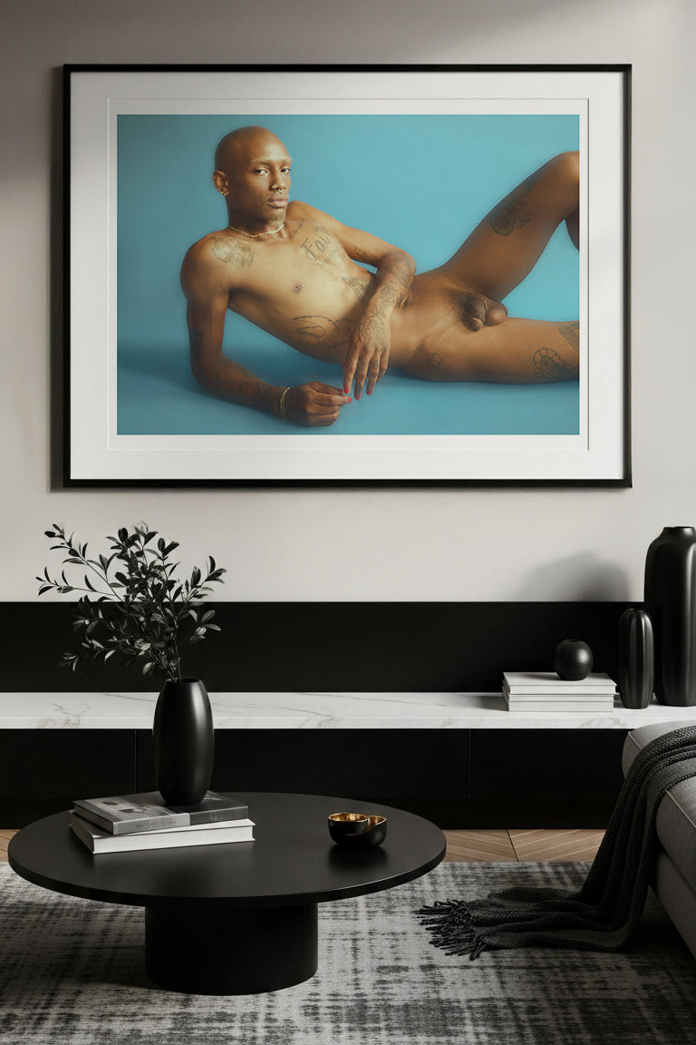 Framed artwork of a nude person on a wall in a modern living room.