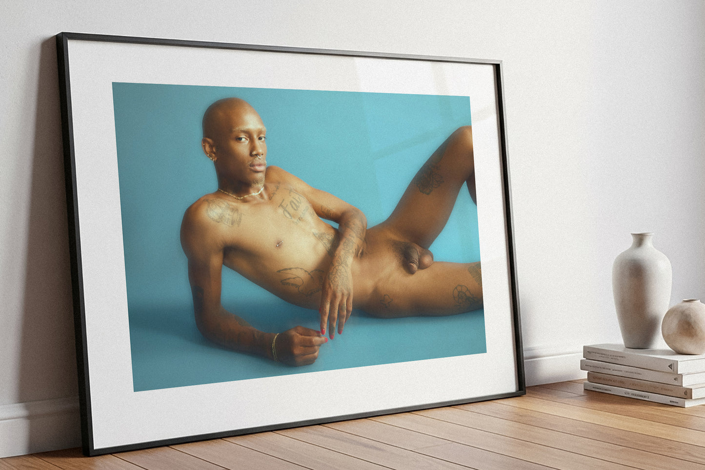 Framed artwork of a nude person on a blue background, leaning against a white wall. Limited Edition Fine Art Print.