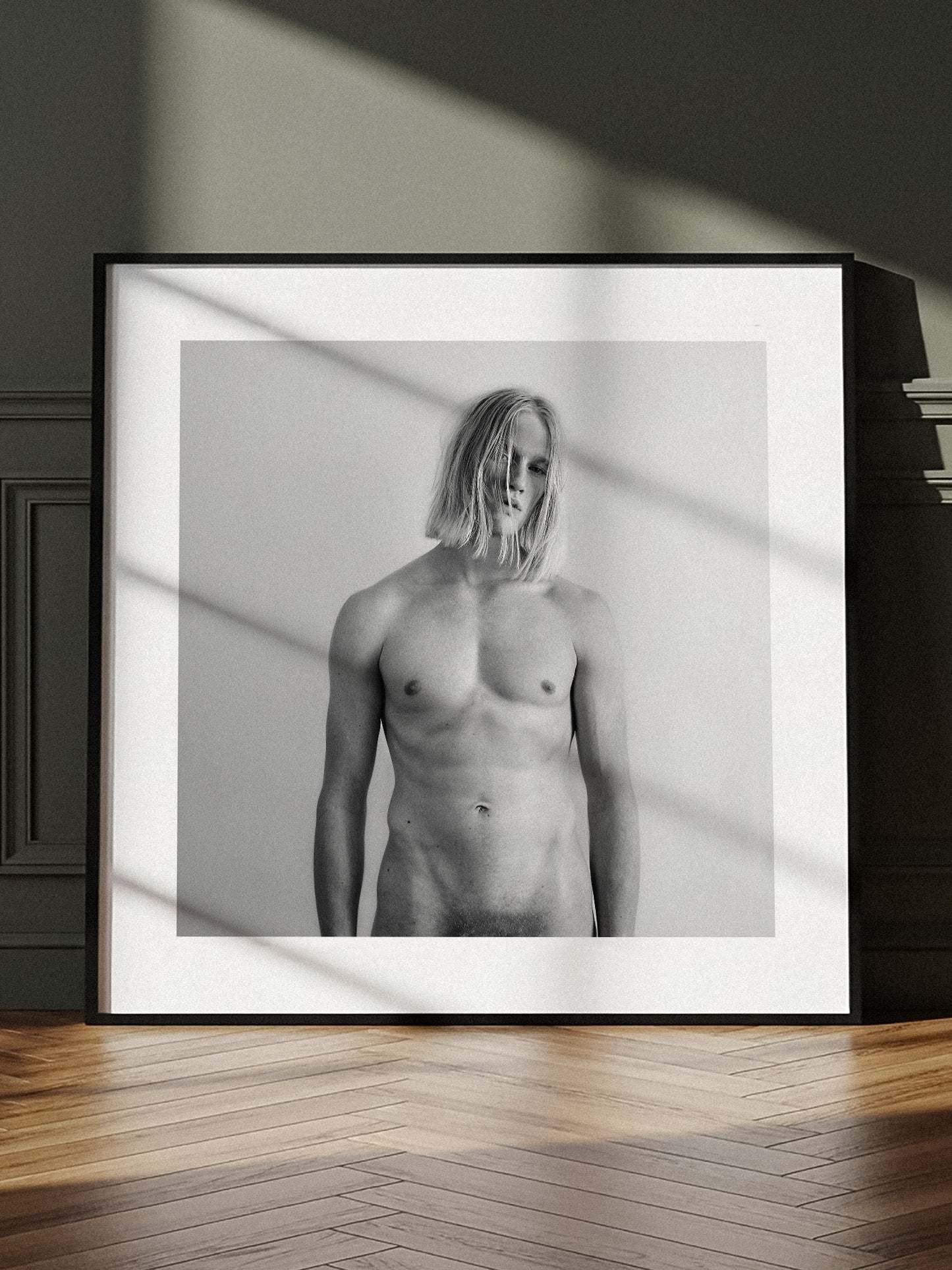 Framed black and white fine art print portrait of a shirtless male against a neutral background. Archival quality.