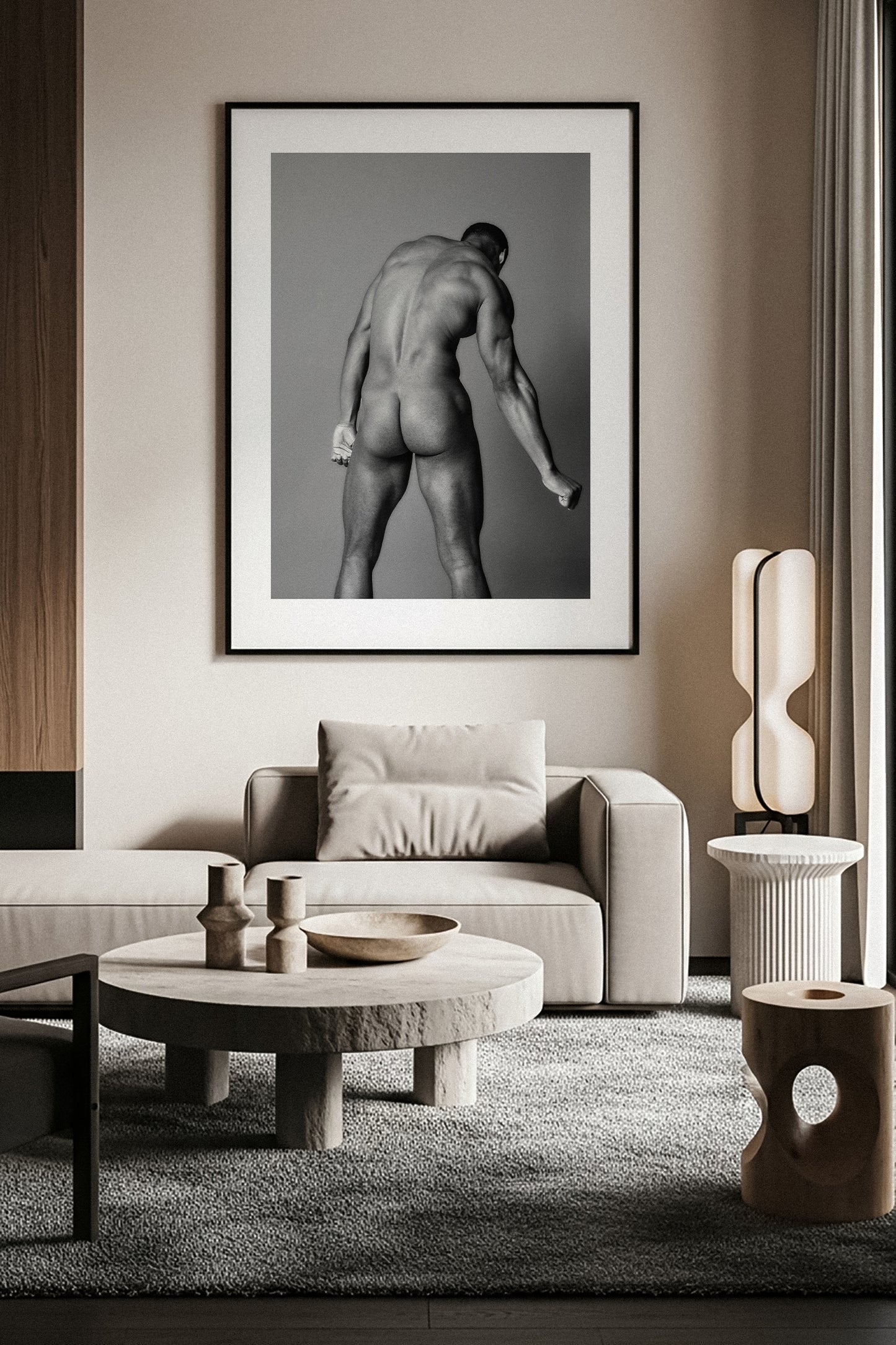 Modern living room with a framed black and white fine art nude photograph on the wall