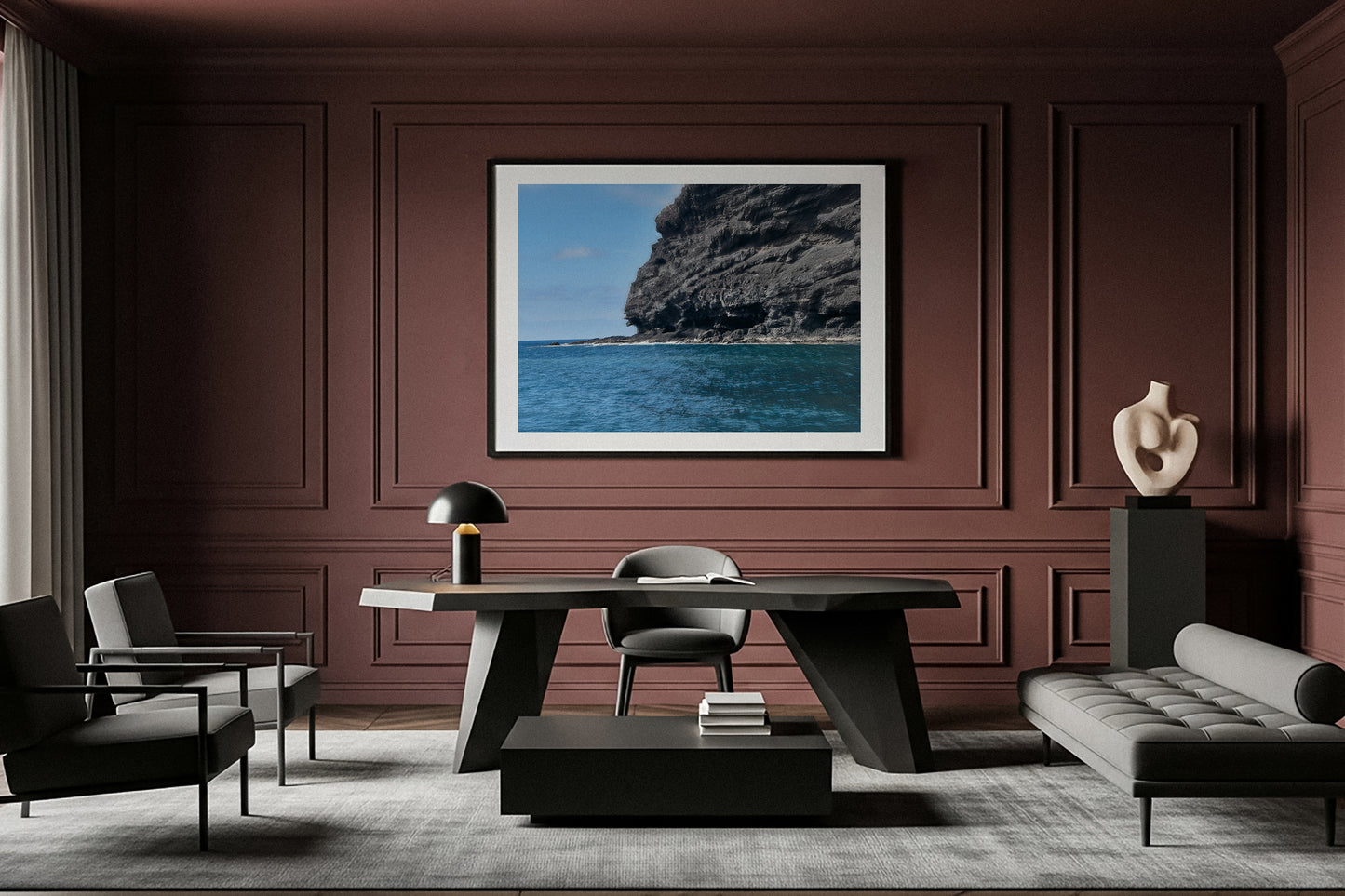 Modern living room with a large framed fine art picture of a coastal scene on a brown wall.