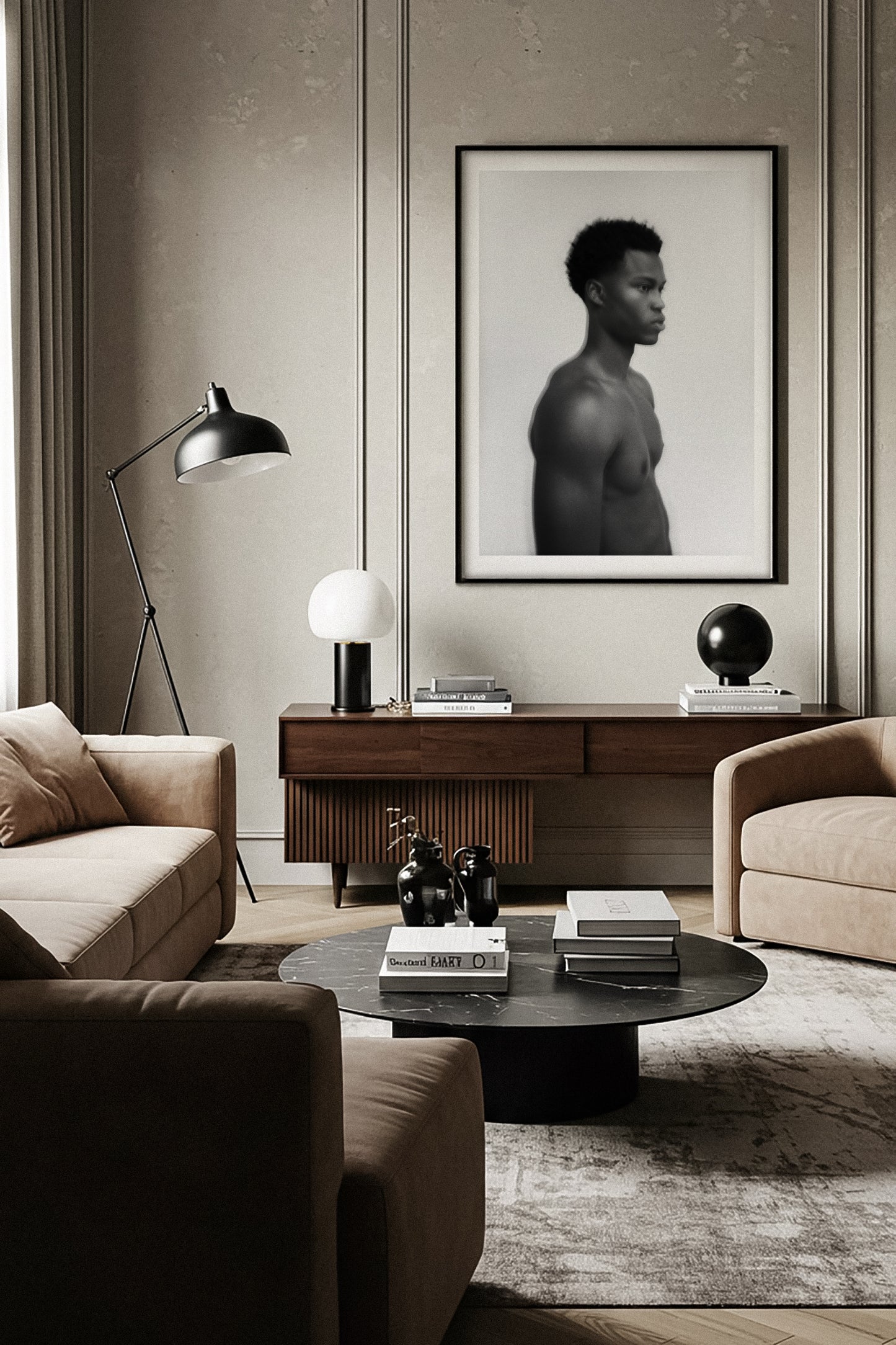 Modern living room with beige sofa, coffee table, and fine art black and white portrait of a male profile