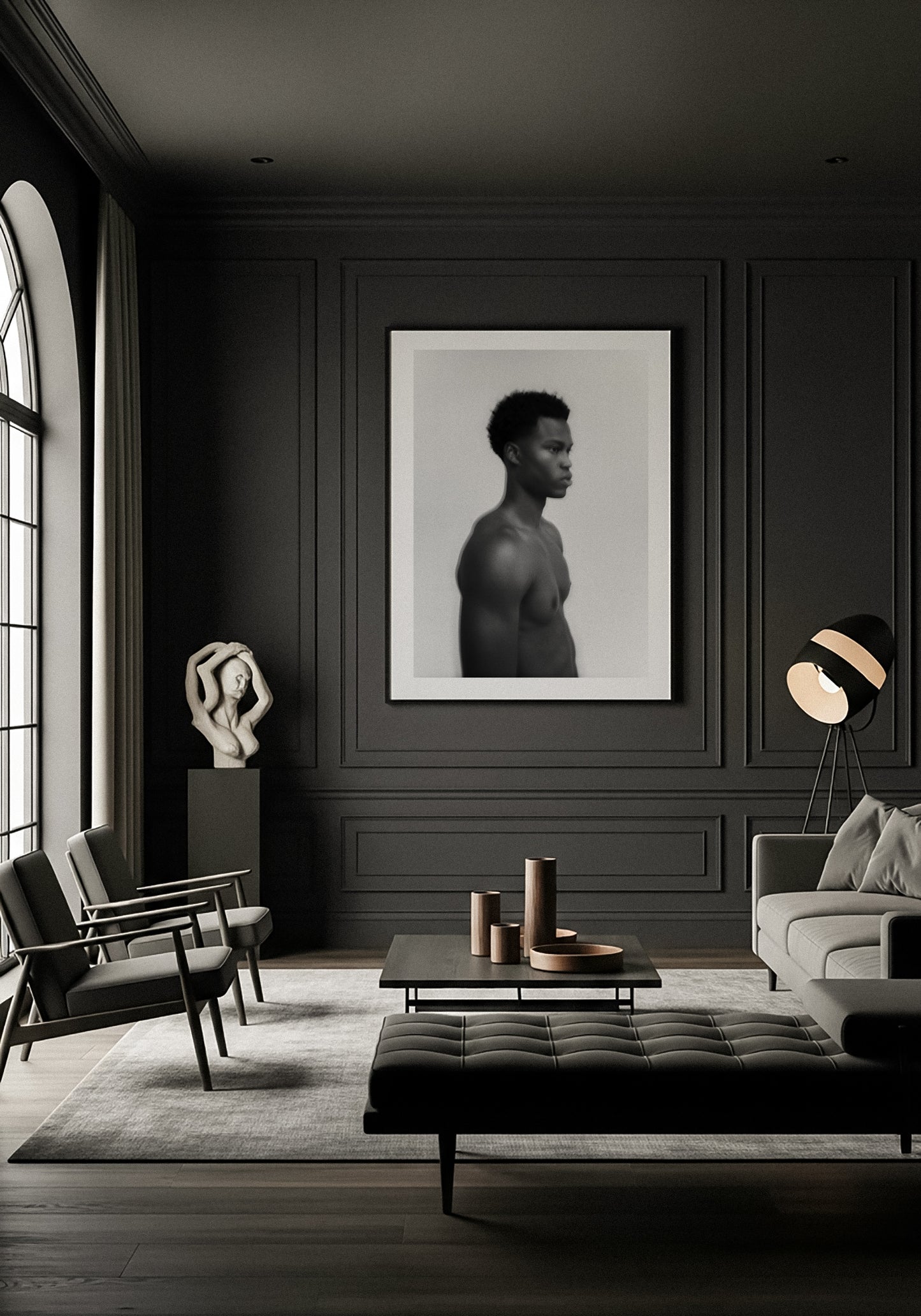 Modern living room with dark walls, furniture, and decor elements. Framed fine art photography of a young man in black and white