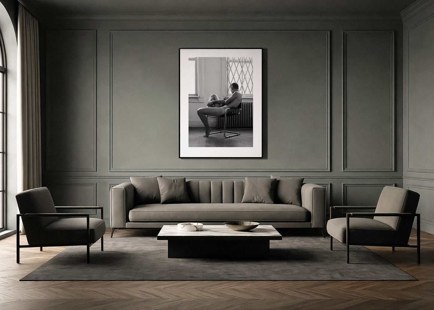 Modern living room with gray sofa, chairs, and a framed black and white fine art photo by Lucas Castro Pardo on the wall.