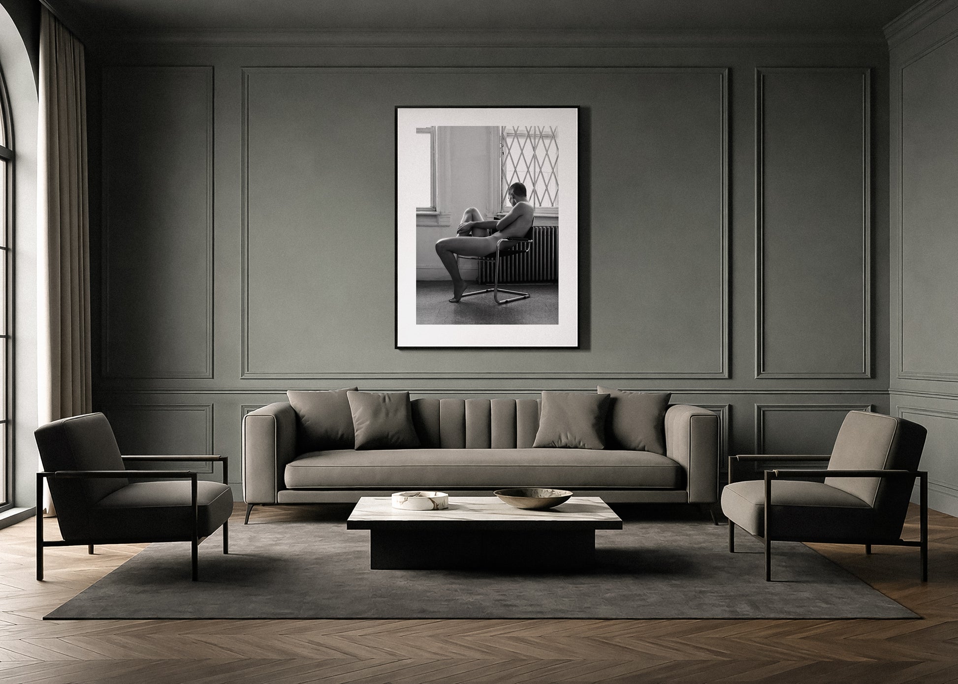 Modern living room with gray sofa, chairs, and a framed black and white fine art photo by Lucas Castro Pardo on the wall.