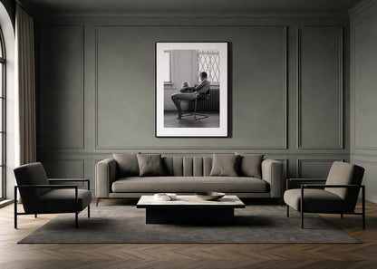 Modern living room with gray sofa, chairs, and a framed black and white fine art photo by Lucas Castro Pardo on the wall.