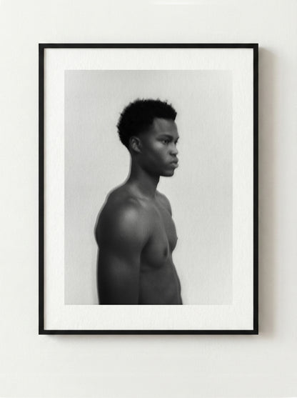 Framed black and white fine art portrait of a shirtless male on a white wall.
