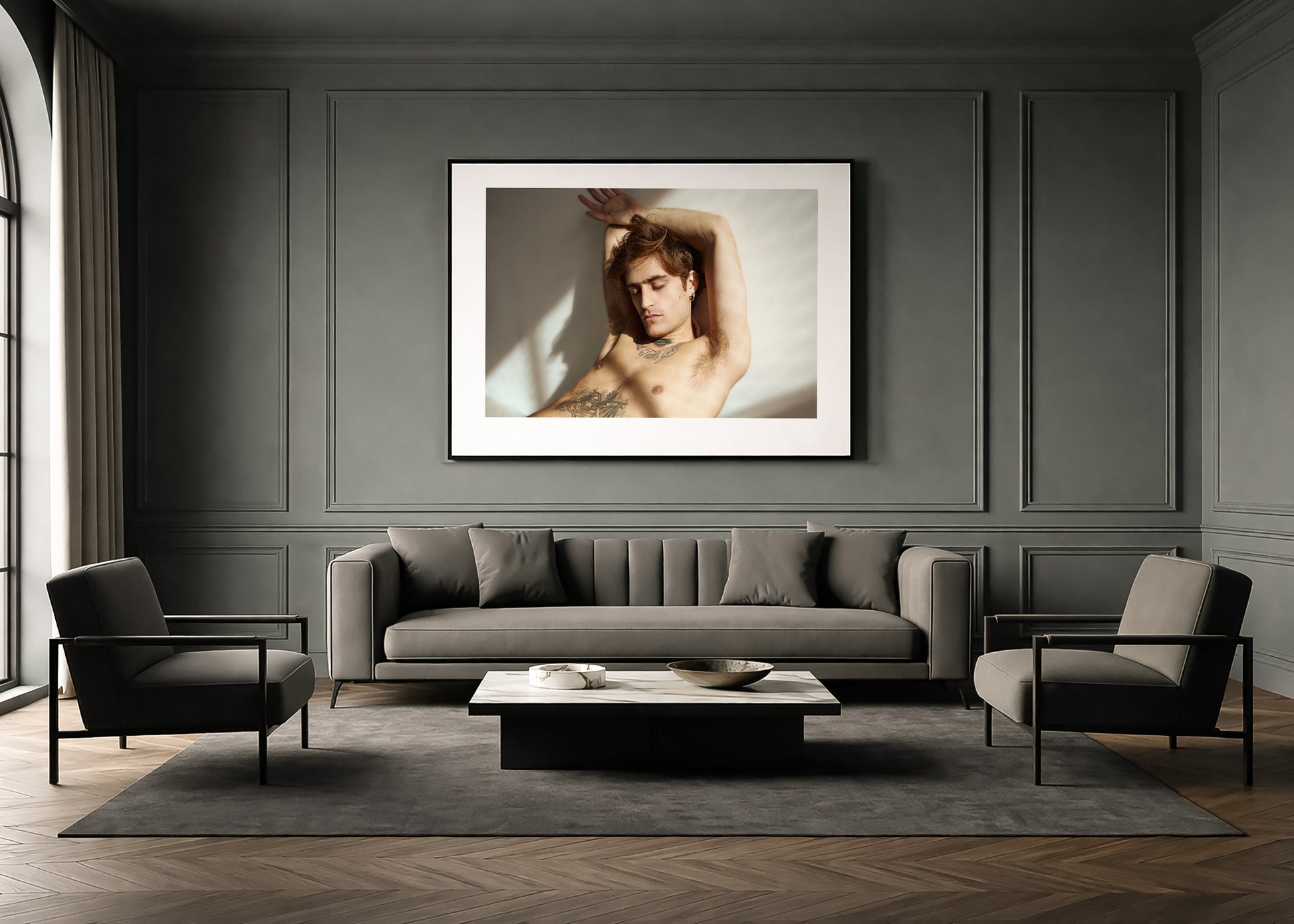 Modern living room with a gray sofa, chairs, and a large framed fine art photograph on the wall.