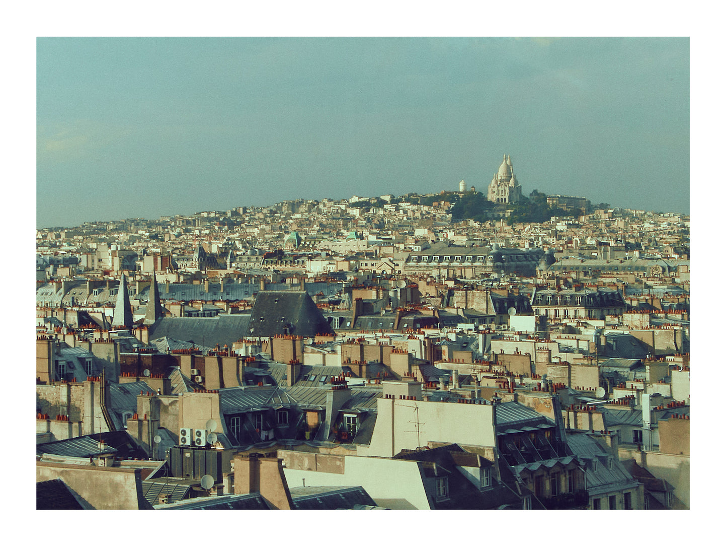 Paris Cityscape with a prominent building on a hill under a clear sky
