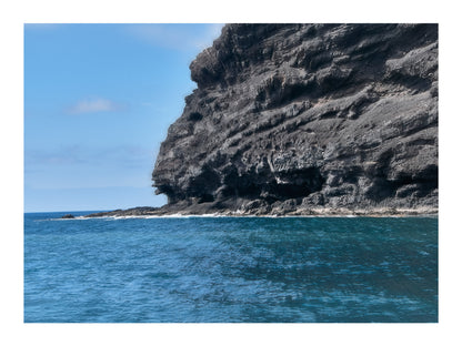 Fine Art Landscape Photography of a Stony cliff by the sea under a clear blue sky