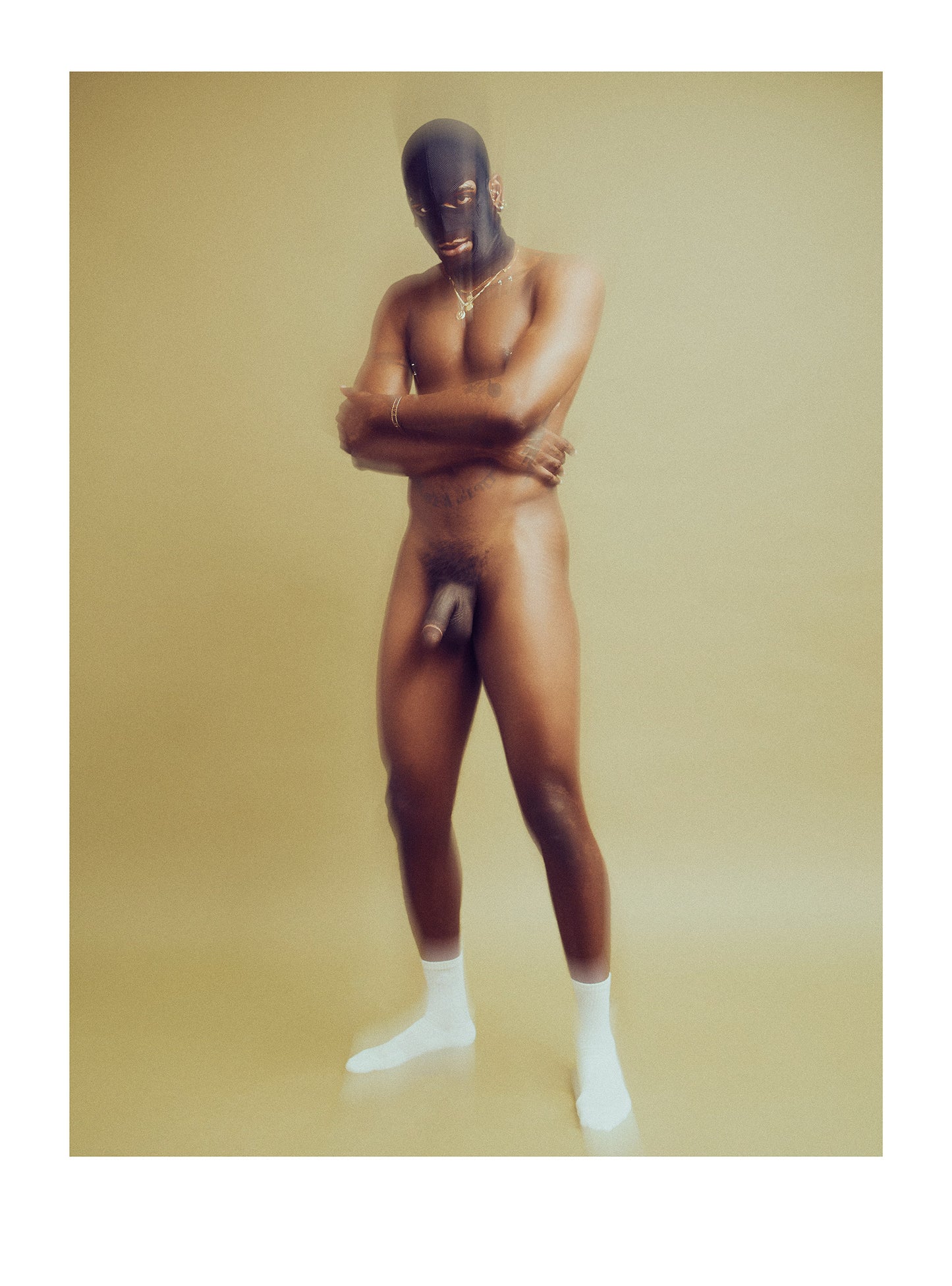 Fine Art Photograph of a Masked Naked man standing with arms crossed against a green background