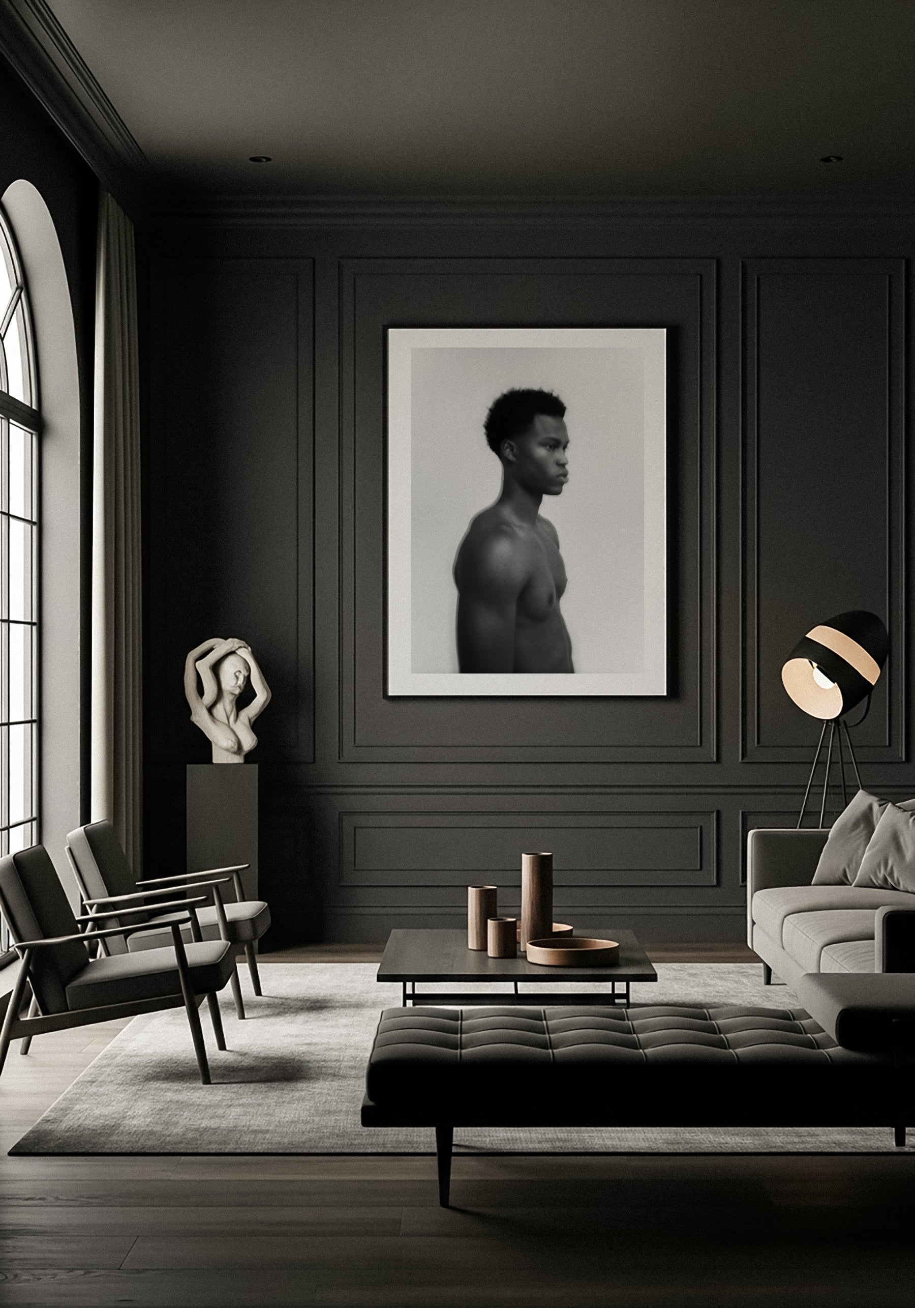 Modern living room with dark walls, furniture, and decor elements. Framed fine art photography of a young man in black and white